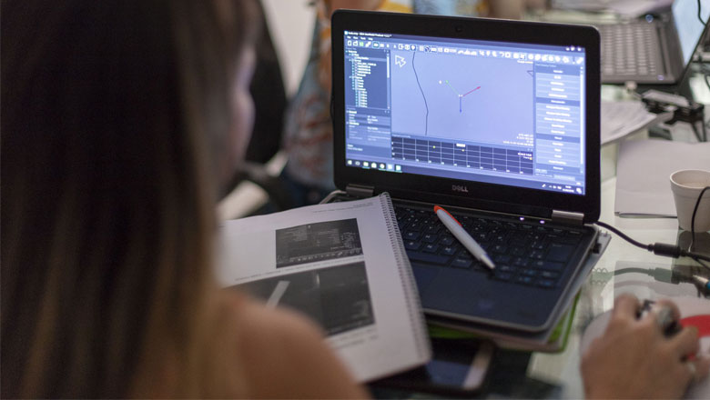 A student learning how to use NaviSuite software on her computer while in the classroom